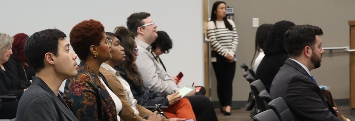 Hero image of a leadership group of individuals in an office meeting